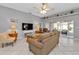 Bright living room featuring comfortable seating and a view to the screened patio at 24415 Buckingham Way, Punta Gorda, FL 33980