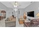 Bright living room with two sofas, a coffee table, and a view into the entryway at 24415 Buckingham Way, Punta Gorda, FL 33980