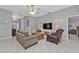 Spacious living room featuring neutral colors, comfy seating, and a large TV at 24415 Buckingham Way, Punta Gorda, FL 33980