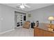 Home office with built-in shelving and comfortable seating at 24415 Buckingham Way, Punta Gorda, FL 33980