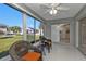 Bright sunroom with wicker furniture offering a view of the backyard at 24415 Buckingham Way, Punta Gorda, FL 33980