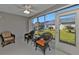 Relaxing sunroom with wicker furniture and a view of the backyard at 24415 Buckingham Way, Punta Gorda, FL 33980