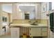 Bathroom with vanity, mirror, and access to a bedroom at 2501 Rio Largo Ct, Punta Gorda, FL 33950