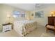 Spacious bedroom with floral bedding and a ceiling fan at 2501 Rio Largo Ct, Punta Gorda, FL 33950