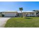 Ranch-style home with attached garage and well-manicured lawn at 2501 Rio Largo Ct, Punta Gorda, FL 33950