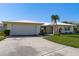 Single-story home exterior with attached garage and mature landscaping at 2501 Rio Largo Ct, Punta Gorda, FL 33950