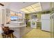 Kitchen features retro green cabinets and a breakfast bar at 2501 Rio Largo Ct, Punta Gorda, FL 33950