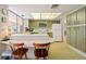 Retro kitchen with green cabinets and breakfast bar at 2501 Rio Largo Ct, Punta Gorda, FL 33950