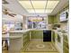 Retro kitchen with green cabinets and view to the living area at 2501 Rio Largo Ct, Punta Gorda, FL 33950