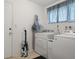 Bright laundry room with washer, dryer, and ironing board at 2501 Rio Largo Ct, Punta Gorda, FL 33950