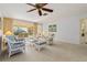 Living room featuring wicker furniture, pool view, and ceiling fan at 2501 Rio Largo Ct, Punta Gorda, FL 33950