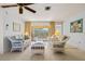 Living room with wicker furniture and sliding glass doors to the pool at 2501 Rio Largo Ct, Punta Gorda, FL 33950