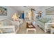 Living room with wicker furniture and view to dining area at 2501 Rio Largo Ct, Punta Gorda, FL 33950