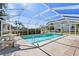 Refreshing pool with screened enclosure and patio furniture at 2501 Rio Largo Ct, Punta Gorda, FL 33950