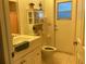 Bathroom with a vanity, toilet, and exterior access at 25200 Derringer Rd, Punta Gorda, FL 33983