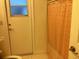 Simple bathroom with a toilet and exterior access at 25200 Derringer Rd, Punta Gorda, FL 33983