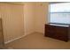 Bedroom with dresser, window, and sliding door at 25200 Derringer Rd, Punta Gorda, FL 33983