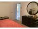 Bedroom with a dresser and access to another room at 25200 Derringer Rd, Punta Gorda, FL 33983