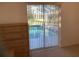 Bedroom with view of pool through sliding doors at 25200 Derringer Rd, Punta Gorda, FL 33983