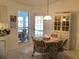 Bright dining area with a round table and chairs near the kitchen at 25200 Derringer Rd, Punta Gorda, FL 33983