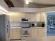 Modern kitchen with white cabinets and stainless steel appliances at 25200 Derringer Rd, Punta Gorda, FL 33983