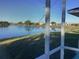 Scenic view of a lake and houses from a screened porch at 25200 Derringer Rd, Punta Gorda, FL 33983