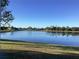 Peaceful lake view with lush green grass at 25200 Derringer Rd, Punta Gorda, FL 33983