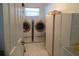 Bright laundry room with washer, dryer, and cabinets at 25200 Derringer Rd, Punta Gorda, FL 33983