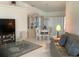 Bright living room with a gray couch, dining table, and flat-screen TV at 25200 Derringer Rd, Punta Gorda, FL 33983