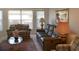 Spacious living room featuring a leather sofa and large windows at 25200 Derringer Rd, Punta Gorda, FL 33983