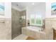 Spa-like bathroom with soaking tub, walk-in shower, and window at 3112 Tripoli Blvd, Punta Gorda, FL 33950