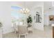 Bright breakfast nook with glass table and woven chairs, adjacent to kitchen at 3112 Tripoli Blvd, Punta Gorda, FL 33950