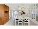 Bright dining area with a white table, chairs, and built-in wooden storage at 3310 Loveland Blvd # 2304, Punta Gorda, FL 33980