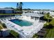 Community pool area with lounge chairs and fencing at 3310 Loveland Blvd # 2304, Punta Gorda, FL 33980