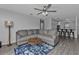 Spacious living room with gray sectional sofa and wood-look floors at 4846 Butterfly Ln, North Port, FL 34288