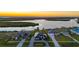 Beautiful aerial view of waterfront homes at sunset, featuring lush landscapes and private docks at 5117 Collingswood Blvd, Port Charlotte, FL 33948