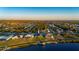 Aerial view of waterfront home with a private dock and beautiful waterway views at sunset at 5117 Collingswood Blvd, Port Charlotte, FL 33948
