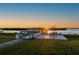 Sunset view from a private backyard dock with seating area at 5117 Collingswood Blvd, Port Charlotte, FL 33948