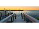 Scenic view of a private boat dock at sunset, providing convenient access to waterways for boating and recreation at 5117 Collingswood Blvd, Port Charlotte, FL 33948