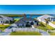 Stunning waterfront home with lush landscaping, a pristine white fence, and a gorgeous dark roof at 5117 Collingswood Blvd, Port Charlotte, FL 33948