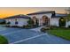 Elegant single-story home featuring manicured landscaping, a paved driveway, and a welcoming entrance at dusk at 5117 Collingswood Blvd, Port Charlotte, FL 33948
