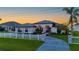 Beautiful single-story home with manicured lawn, decorative fence, and paved driveway, creating a welcoming curb appeal at 5117 Collingswood Blvd, Port Charlotte, FL 33948