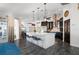 An open kitchen with a large island, pendant lighting, sleek black cabinetry, and stainless steel appliances at 5117 Collingswood Blvd, Port Charlotte, FL 33948