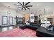 Expansive living room boasts a ceiling fan and brick accent wall perfect for relaxation and entertaining at 5117 Collingswood Blvd, Port Charlotte, FL 33948