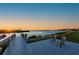 Waterfront deck with chairs overlooking a scenic sunset view, perfect for relaxation at 5117 Collingswood Blvd, Port Charlotte, FL 33948
