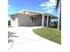 Tan single story home with covered porch and carport, set back from the street at 522 Clarion Pl, North Port, FL 34287