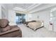 Main bedroom with water views, featuring a comfy bed and sliding glass doors to lanai at 528 Madrid Blvd, Punta Gorda, FL 33950