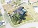 Aerial view of a well-kept home featuring an inground pool and a large, shady tree at 7359 Van Lake Dr, Englewood, FL 34224
