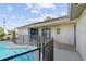 Backyard with a fenced pool, covered patio, and an updated exterior paint job at 7359 Van Lake Dr, Englewood, FL 34224