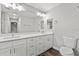 Modern bathroom with double vanity, large mirror, and updated fixtures at 7359 Van Lake Dr, Englewood, FL 34224